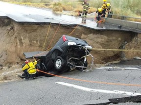 In this photo provided by the CAL FIRE/Riverside County Fire Department, emergency crews respond after a pickup truck crashed into the collapse of an elevated section of Interstate 10, Sunday, July 19, 2015, in Desert Center, Calif. (Chief Geoff Pemberton/CAL FIRE/Riverside County Fire via AP)
