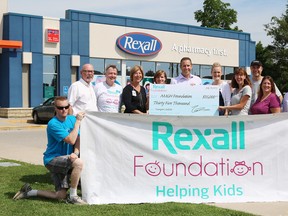 The Rexall Foundation made a $35,000 donation to the Alexandra Marine and General Hospital Foundation during the Rexall Customer Appreciation Event in Goderich on July 18. Back (left to right): Myles Murdock, Bill Hewitt, Lori Merner, Shannon LaHay, Paul Dale, Shannon Conliffe, Dr. Kim Spacek, Dr. Stan Spacek, Patti Harnett and Iryna Barkova. Front: Alex and Olivia Hewitt.