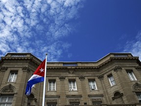 The Cuban flag flutters at the Cuban Embassy in Washington July 20, 2015. The Cuban flag was raised over Havana's embassy in Washington on Monday for the first time in 54 years as the United States and Cuba formally restored relations, opening a new chapter of engagement between the former Cold War foes. REUTERS/Jonathan Ernst