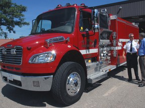 St. Thomas Fire Chief Rob Broadbent, left, shows CAO Wendell Graves some of the features of the department’s new tanker truck. The $320,000 vehicle arrived from its manufacturing facility in Florida Monday morning.