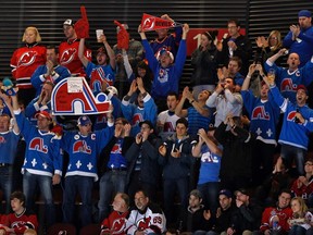 Members of Nordiques Nation cheer during NHL action between the New Jersey Devils and Montreal Canadiens in Newark, N.J., on March 16, 2013. Quebecor announced on July 20, 2015 that they submitted a bid to the NHL to bring a team back to Quebec City. (Adam Hunger/Reuters/Files)