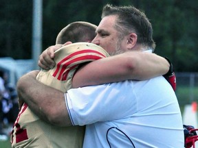 Floyd Graham and head coach Jake Cherski of the Sarnia Imperials embrace after Saturday's 31-30 victory in Oakville. The club played in honour of John Cooke, a long-time fan of the team and father of Grahamís fiance, Jessica, who died Wednesday. (Cathie Bell/Handout)