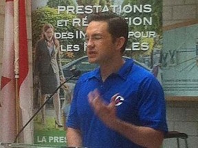 Pierre Poilievre's decision to wear a Conservative Party golf shirt during an announcement Monday, July 20, 2015 on child care benefits payments is being criticized by the opposition as an attempt to put a party brand on public money. (THE CANADIAN PRESS/ HO/Andrew Pinsent, News 95.7-CJNI Halifax)