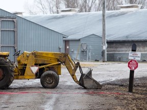 A tractor blocks a lane way leading into a turkey farm where Canada Food Inspection Agency inspectors are investigating at a farm on Highway 2, one of eight in Oxford County in a containment zone following a bird flu outbreak, west of Woodstock, recently. (CRAIG GLOVER/The London Free Press)