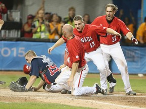 Pete Orr slides safely into home plate to deliver Pan-Am gold for Team Canada against Team USA on Sunday night in Ajax. (VERONICA HENRI/TORONTO SUN)