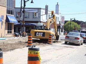 Crews perform underground pipe work on Elgin Street downtown on Thursday.