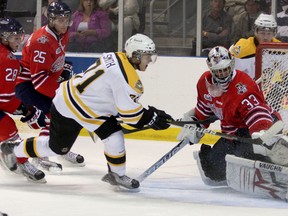 Kingston Frontenacs forward Jacob Smith (71) shoots on Oshawa Generals goalie Dan Altshuller during OHL action in 2011. Smith will return home to Sudbury this year to play for the Laurentian Voyageurs men's hockey team. Postmedia Network file photo