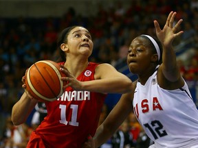 Team Canada’s Natalie Achonwa drives past Stephanie Mavunga of Team USA during their gold-medal match at the Pan Am Games on Monday night. (DAVE ABEL/TORONTO SUN)