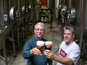 Bill White, left, of Ontario Craft Brewers, and Jeff Cooper, of Toronto's Mill St. Brewery, share a toast. (Postmedia Network files)