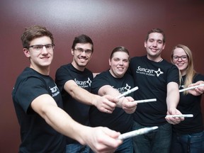 Derek Jouppi of Suncayr, left, and his teammates Andrew Martinko, Peter Mucha, Chad Sweeting, and Rachel Pautler show off their product in Waterloo on Thursday, March 26, 2015. Suncayr develops UV-responsive marker ink that tells you when to reapply sunscreen. (The Canadian Press/Hannah Yoon)