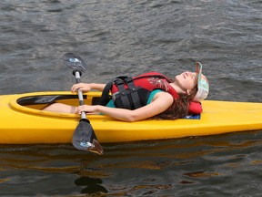 Quinn Gardner, 10, takes a brief rest from kayak lessons at the Sudbury Canoe Club on Ramsey Lake in Sudbury, Ont. on Monday July 20, 2015. The club offers one-week sessions for kids aged six to 12, in a number of disciplines, including canoeing and kayaking. John Lappa/Sudbury Star/Postmedia Network