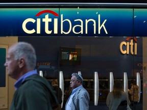 People walk past a Citibank branch in New York in this file photo taken October 15, 2013. (REUTERS/Andrew Kelly/Files)