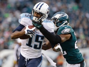 In this Nov. 23, 2014, file photo, Tennessee Titans’ Justin Hunter, left, is tackled by Philadelphia Eagles’ Brandon Boykin during NFL action in Philadelphia. (AP Photo/Matt Rourke, File)