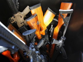 Guns that were turned in by their owners are seen in a trash bin at a gun buyback held by the Los Angeles Police Department in this December 26, 2012 file photo.  (REUTERS/David McNew)