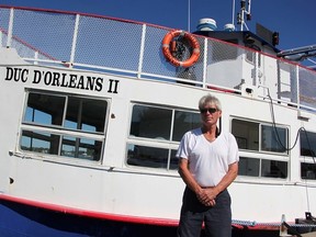 Ken Bracewell, captain of the Duc d'Orleans II cruise ship, stands beside the vessel Tuesday in Sarnia. The ship's canvas top was damaged by Saturday's storm, and vandals caused additional damage early Sunday. (Tyler Kula/Sarnia Observer/Postmedia Network)
