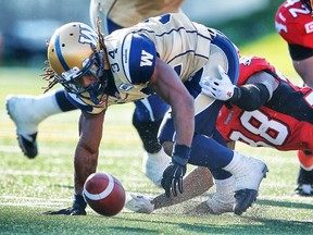 Winnipeg Blue Bombers Paris Cotton with a fumble in front of Buddy Jackson of the Calgary Stampeders during CFL football in Calgary, Alta. on Saturday July 18, 2015. Al Charest/Calgary Sun/Postmedia Network