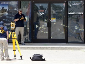 FBI agents continue their investigation at the Armed Forces Career Center in Chattanooga, Tennessee July 17, 2015. Four U.S. Marines were killed on Thursday by a suspected gunman the FBI has confirmed as Mohammod Youssuf Abdulazeez, who opened fire at two military offices in Chattanooga before being fatally shot by police.  REUTERS/Tami Chappell