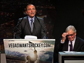 Gary Bettman, commissioner of the National Hockey League ddresses the crowd as Bill Foley, chairman, Fidelity National Financial, Inc., wipes his forehead during a press conference at the MGM Grand Ballroom in Las Vegas on Feb. 10, 2015. (THE CANADIAN PRESS/ AP/The Sun, L.E. Baskow LAS VEGAS REVIEW-JOURNAL OUT)