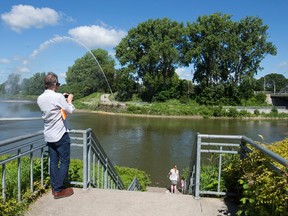 Calvin Brook, of the firm Brook McIlroy, takes photos at the forks of the Thames as he and other Back to the River design contest finalists tour along the Thames River in Ivey Park during a fact-finding visit to London Tuesday. (CRAIG GLOVER, The London Free Press)