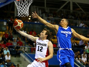 Canada’s Brady Heslip goes up for a basket agaisnt Rigoberto Mendoza of the Dominican Republic during men’s basketball action on Tuesday night. (Dave Abel/Toronto Sun)