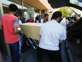 Family and friends load the coffin at a funeral service for four-year old Ramy Salih on Tuesday. (JACK BOLAND, Toronto Sun)
