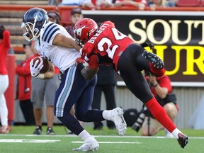 Calgary Stampeders' Joe Burnett tries to make a tackle on  Toronto Argonauts' Anthony Coombs on July 13. (Mike Drew, Postmedia Network)