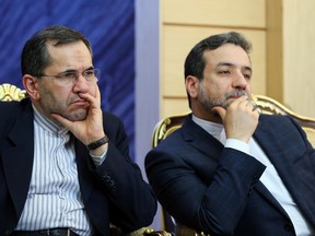 Iran's Deputy Foreign Minister Abbas Araghchi, right, and Majid Takht-e-Ravachi, who are members of Iran's nuclear negotiating team sit in at a news briefing by Foreign Minister and top nuclear negotiator, Mohammad Javad Zarif, and the head of Iran's Atomic Energy Organization, Ali Akbar Salehi. (AP Photo/Ebrahim Noroozi)