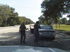 A Waller County Department of Public Safety officer points a Taser as he orders Sandra Bland out of her vehicle, in this still image captured from the police dash camera video from the traffic stop of Bland's vehicle in Prairie View, Texas, July 10, 2015. (REUTERS/The Texas Department of Public Safety/Handout via Reuters)