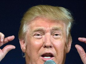 Republican presidential hopeful Donald Trump remarks about Texas Gov. Rick Perry's glasses at his South Carolina campaign rally in Bluffton, S.C., Tuesday, July 21, 2015.  (AP Photo/Stephen B. Morton)