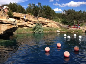 This June 6, 2015 file photo shows a boy leaping into the water at Blue Hole State Park in Santa Rosa, N.M. Blue Hole is part of the New Mexico Tourism Department's "New Mexico True" campaign, an effort aimed at drawing more tourists to the state. (AP Photo/Susan Montoya Bryan, File)