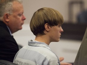 Dylann Roof, the 21-year-old man charged with murdering nine worshippers at a historic black church in Charleston last month, listens to the proceedings with assistant defense attorney William Maguire during a hearing at the Judicial Center in Charleston, South Carolina July 16, 2015.  (REUTERS/Randall Hill)