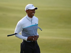 Tiger Woods smiles as he waits to putt on the 18th hole during the second round of the British Open at the Old Course, St. Andrews, Scotland, on Saturday, July 18, 2015. (Jon Super/AP Photo)