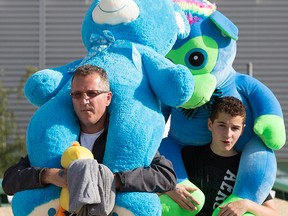 K-Days patrons head home with giant plush toys, in Edmonton Alta. on Wednesday July 22, 2015.