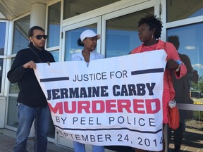 Lorna Robinson (R), Jermaine Carby's mother, La Tanya Grant (C), Carby's cousin, and Kabir Joshi (L), a supporter, after a five-hour meeting with Ontario's Special Investigations Unit Wednesday, July 22, 2015. (Nick Westoll/Toronto Sun)