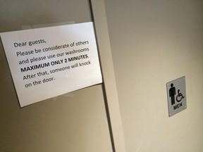 A two-minute warning sign at a Tim Hortons' washroom at Queens Quay W. and Rees St. Wednesday, July 22, 2015. (Jack Boland/Toronto Sun)