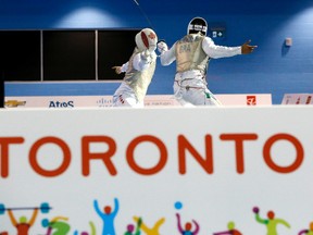 Canada's Maximilien Van Haaster, left, competes against Brazil's Ghislain Perrier during their men's foil individual quarterfinal match in Toronto at the Pan American Games on July 22, 2015. (AP Photo/Julio Cortez)