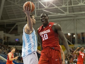 Canada’s Anthony Bennett (right) reacts after scoring against Argentina as Federico Aguerre holds the ball during their men’s basketball game Wednesday night. (The Canadian Press)