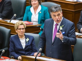 Minister of Finance Charles Sousa tables the 2015 Ontario Budget at Queen's Park in Toronto, Ont. on Thursday April 23, 2015.  Sitting with him is Ontario Premier Kathleen Wynne. Ernest Doroszuk/Toronto Sun/Postmedia Network