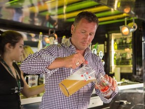 Jeremy Parsons makes a cocktail using beer at the 2014 Toronto Festival of Beer. Brewers are experimenting with different ingredients in their beer recipes and mixologists are blending those beers with bitters, fruits and mixes to create beer cocktails. THE CANADIAN PRESS/ HOBeerlicious Inc.