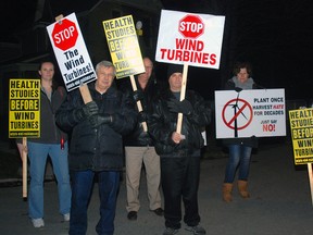 Protesters opposed to wind turbines in Dutton/Duwnich greet traffic arriving at the Dutton/Dunwich Community Centre in December 2013.