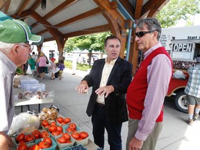 JASON MILLER/THE INTELLIGENCER
Belleville Farmers’ Market vendor, Clifford Foster, speaks with Neil Ellis, the Liberal candidate for the Bay of Quinte riding, and Scarborough MP and environment critic John McKay, on Thursday.