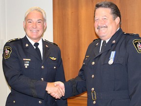Chatham-Kent police Chief Gary Conn, left, congratulated Insp. Jeff Littlewood during a media briefing to name the 31-year police veteran as deputy Chief designate of the Chatham-Kent Police Service on Thursday July 23, 2015 in Chatham, Ont. (Vicki Gough/Chatham Daily News/Postmedia Network)