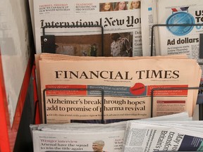 Copies of the Financial Times newspaper sit in a rack at a newsstand in London, Britain July 23, 2015. (REUTERS/Peter Nicholls)