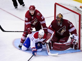 Canadiens forward Brendan Gallagher (11) is knocked to the ice by Coyotes defenceman Michael Stone as goalie Mike Smith defends during NHL action at Gila River Arena in Glendale, Ariz., on March 7, 2015. (Matt Kartozian/USA TODAY Sports)