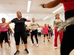 Women do their dance moves during a Zumba exercise class in a low-income neighborhood of Denver May 15, 2012. REUTERS/Rick Wilking