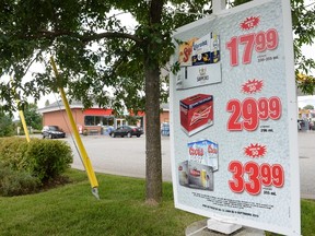 Beer is advertised for sale outside a store in Drummondville, Que., on Thursday, July 23, 2015.  (THE CANADIAN PRESS/Ryan Remiorz)