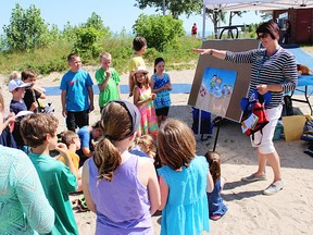 Health promoter Lisa Clark talks water safety at Canatara Park Beach Thursday with kids in a London Bridge Child Care Services summer camp. Lambton Public Health is drawing awareness to its Water Wise program during National Drowning Prevention Week. (Tyler Kula, The Observer)