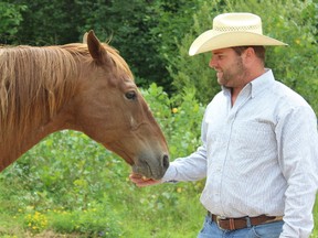SAMANTHA REED/FOR THE INTELLIGENCER
Casey Trudeau, creator of the Tweed Stampede and Jamboree, feeds his horse, Junior, Wednesday afternoon in Trudeau park. Casey is encouraging everyone to come enjoy the family friendly event.