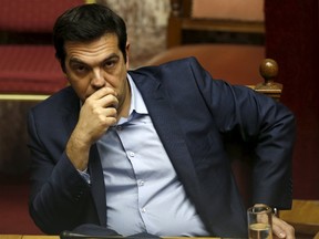 Greek Prime Minister Alexis Tsipras looks on during a parliamentary session in Athens, Greece July 23, 2015. Greece's leftist government tried on Wednesday to contain a rebellion in Prime Minister Alexis Tsipras' Syriza party ahead of a vote in the evening on reforms required to start talks on a rescue deal. REUTERS/Yiannis Kourtoglou
