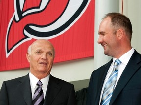 Former Devils coach Peter DeBoer (right) with then-New Jersey GM Lou Lamoriello after DeBoer had been hired as coach in 2011. DeBoer says contrary to public opinion, his GM never interfered in his coaching decisions. (REUTERS/PHOTO)